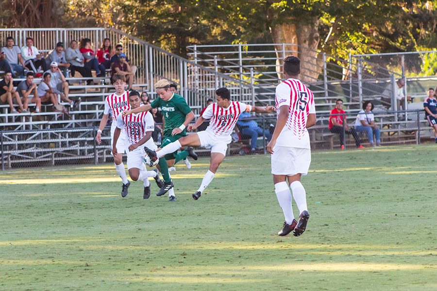 Sacramento State junior defender Jack Larter fights through three California State University, Northridge defenders to advance the ball Sept. 28 at Hornet Field.