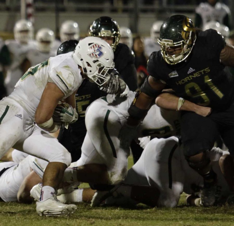 Sacramento State sophomore defensive lineman Seperini Togiai Aumua prepares to tackle Cal Poly senior fullback Jared Mohamed Saturday, Nov. 12 at Alex G. Spanos Stadium.