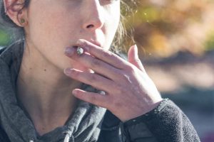 Sacramento State student Crystal Forame smokes a cigarette on campus. The University still has no plan on how to enforce its tobacco-free policy.