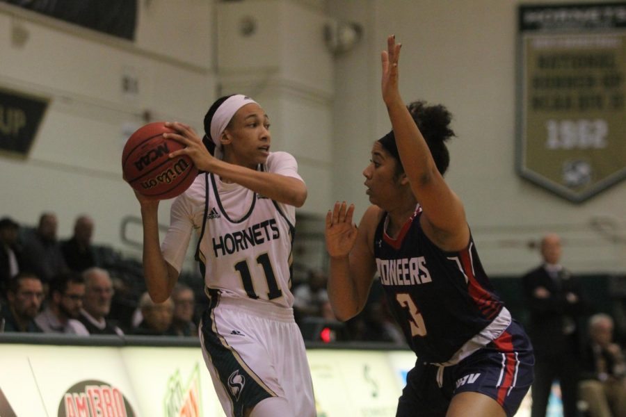 Sacramento State freshman guard 	Dana DeGraffenreid looks to pass the ball against Antelope Valley junior guard 	Samantha Earl Wednesday, Dec. 6 at the Nest. The Hornets defeated the Pioneers 95-62 in their home opener.