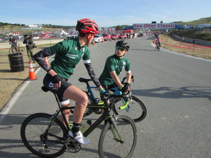 Sacramento State Cycling Club President Makenzie DeLaughder, left, takes a break next to team safety officer Joseph Rempe, right, during the Sea Otter Classic in Santa Cruz, California.