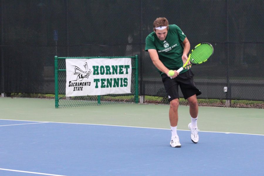 Sacramento State junior Mikus Losbergs backhands the ball during a singles match against Cal Poly Sunday, Jan. 21 at the Sacramento State Courts.