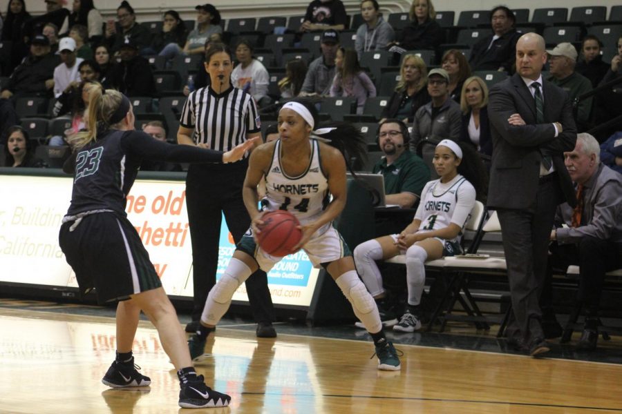 Sacramento State sophomore guard Quayonna Harris tries to escape from the defense of Portland State freshman guard Kylie Jimenez as coach Bunky Harkleroad looks on in an 81-72 loss to the Vikings Saturday, Jan. 27 at the Nest.