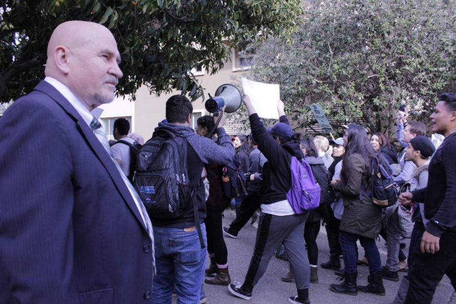 Students protesting the inaugration of President Donald Trump walk past Sac State President Robert Nelsen as he looks on. Those protests were cathartic, but protests of a tuition raise could make a real difference.