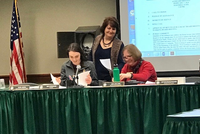 Associated Students, Inc. President Mia Kagianas (left), Lisa Dalton (right) and Gina Curry examine the agena during the ASI meeting on Wednesday. The board voted to remove slates from future election cycles.