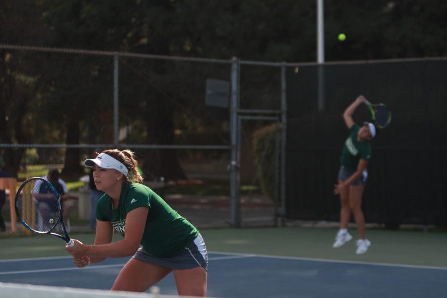 Sacramento State sophomore Carolina Chernyetsky gets ready for her doubles match while freshman Maria Gonzalez serves the ball to UC Irvine at the Sacramento State Courts on Friday, March 30, 2018.