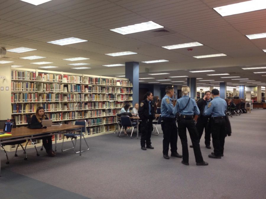 Community service officers from the Sacramento State Police Department gather while officers investigate a fight that broke out in the University Library on Tuesday, March 6, 2018. According to witnesses, the fight started after one person told someone else to leave for sneezing.