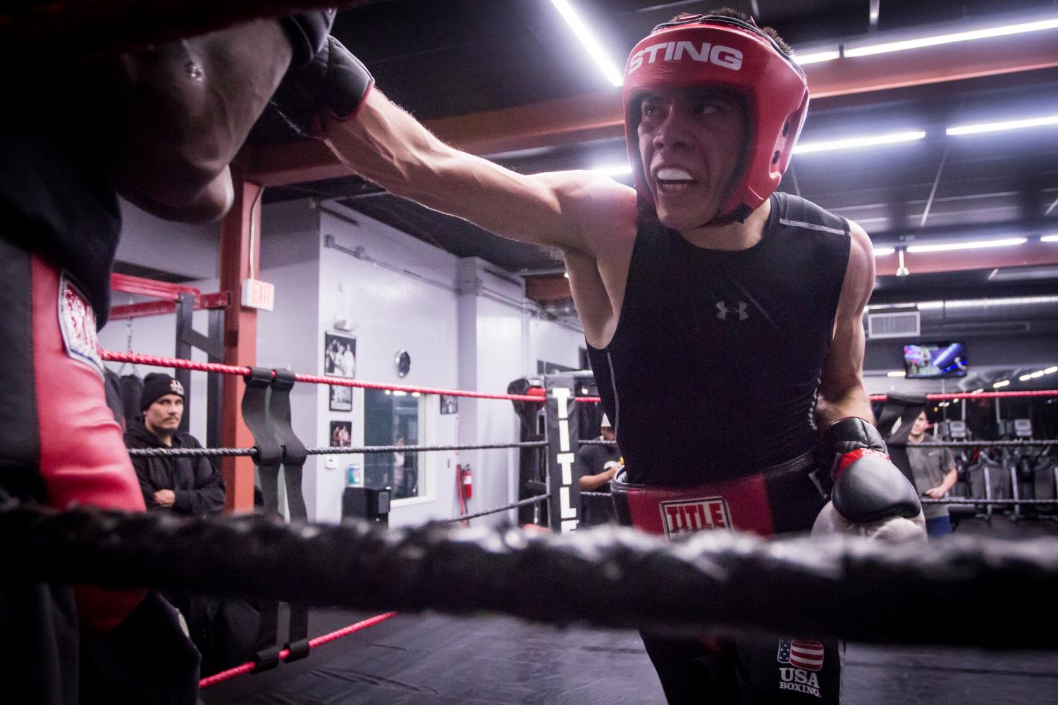 Kevin Montano lands a punch on his sparring partner while training at Midtown Fitness and Boxing in Sacramento on Tuesday, Feb. 20, 2018. Montano, a junior at Sacramento State, secured his spot as a member of Team USA in December and now stays for weeks at a time with all expenses paid at the U.S. Olympic Training Center in Colorado Springs, Colo. in preparation for international competitions with other prospective Olympic athletes.