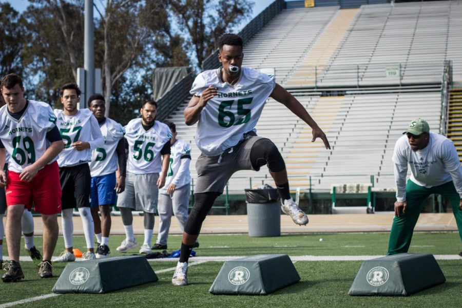 Freshman business major Daveion Hammond performs lateral drills at the instruction of running backs coach James Montgomery during walk-on tryouts for the Sacramento State football team at Hornet Stadium on Tuesday, March 6, 2018. Hammond and 12 other hopefuls were weighed, measured and displayed their skills in front of the coaching staff for the chance to be recruited and train with the possibility of joining the team in the fall.