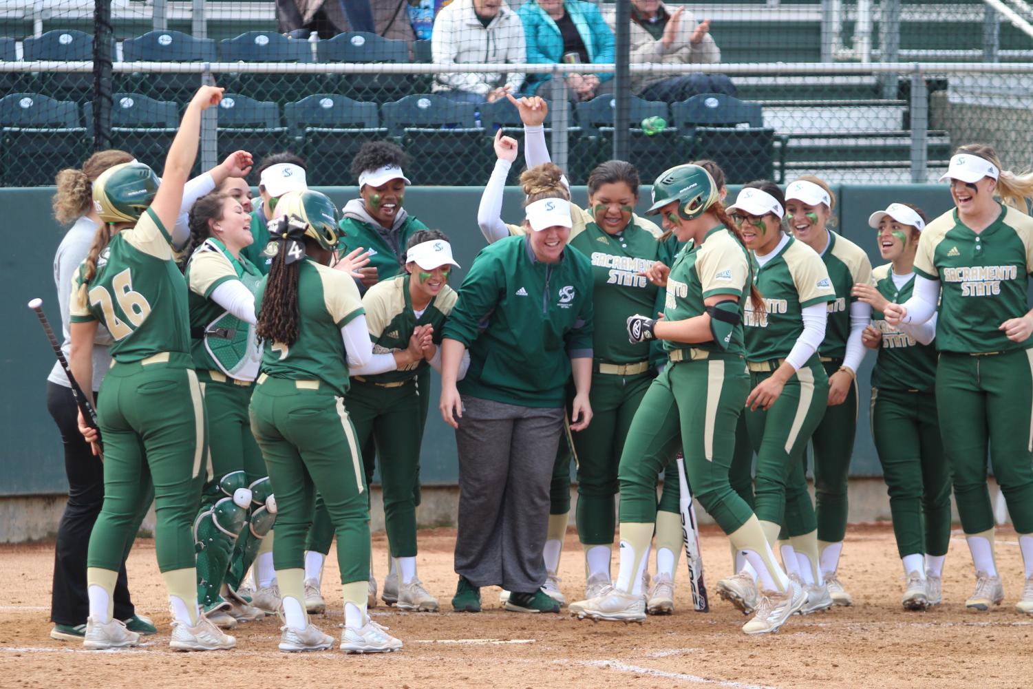 The Sacramento State softball team celebrates as sophomore outfielder Suzy Brookshire, middle, approaches home plate after hitting her second home run of the game against Santa Clara University at Shea Stadium on Saturday, March 17, 2018. The Hornets defeated Santa Clara University 7-1.