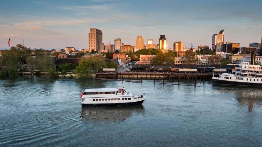 A Hornblower cruise ship moves past downtown Sacramento. 