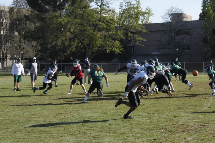 Sacramento State sophomore defensive lineman Killian Rosko, middle, performs a blitz as the defense competes against the offense at the Sac State practice field on Tuesday, April 3, 2018. The football team will compete in its annual spring game on Friday at 6 p.m. at Hornet Stadium.