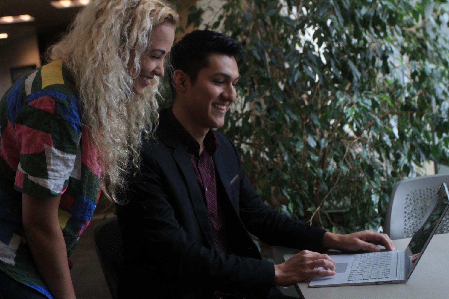 Rachael Dal Porto and Noel Mora look over legislation. Mora and Dal Porto are running on the same presidential ticket for the Associated Students, Inc. elections, which start April 11.