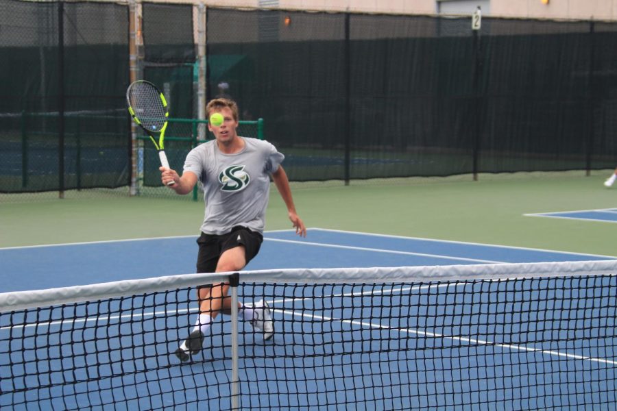 Sacramento State junior Mikus Losbergs goes for a volley during his No. 1 singles match against UC Davis at the Sacramento State Courts on Wednesday, April 11, 2018. The Hornets defeated UC Davis 4-3.
