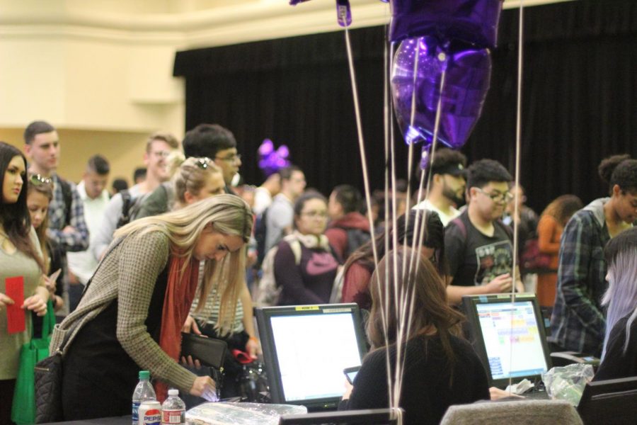 Graduating seniors stand in line to pay for their cap and gown at Grad Fest in the University Union Ballroom on March 28, 2018.