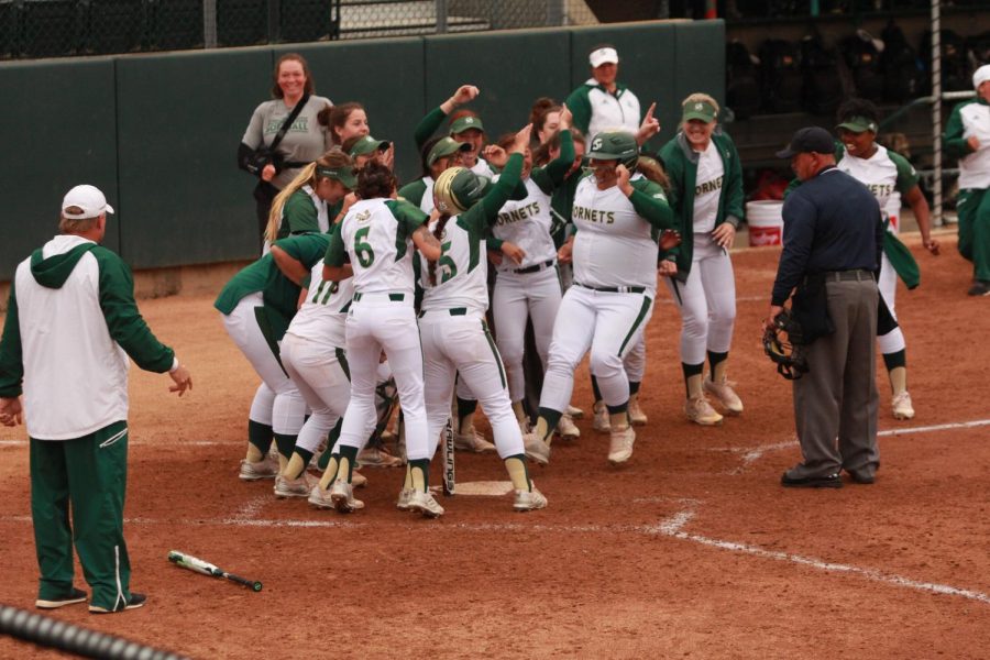The Sacramento State softball team congratulates sophomore designated player Alexxiss Diaz, middle, after she hit a walk-off home run against Portland State at Shea Stadium on Thursday, April 5, 2018. The Hornets defeated the Vikings 1-0 in extra (8) innings.