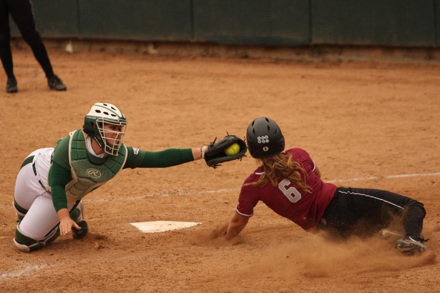 Sacramento State sophomore catcher Jessica Scott tags out Santa Clara University junior second baseman Kelsie Barnard at home plate at Shea Stadium on Wednesday, April 11, 2018. The Hornets defeated the Broncos 3-1.