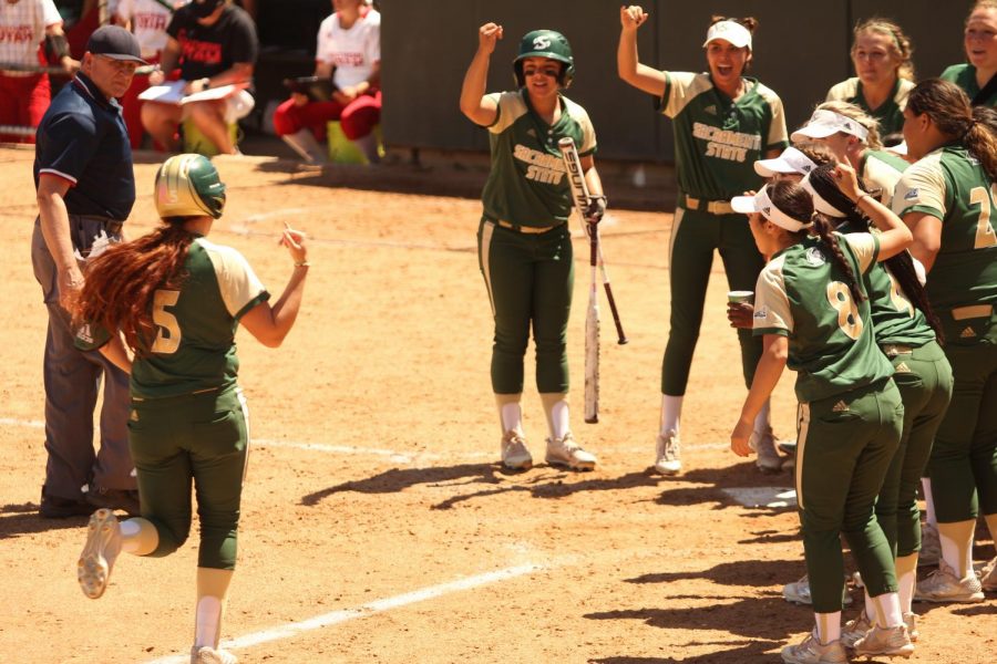Sacramento State sophomore outfielder Suzy Brookshire and her teammates perform the Universitys signature stingers up hand sign after she hit a solo home run against Southern Utah University at Shea Stadium on Saturday, April 21, 2018. The Hornets defeated the Thunderbirds 2-1.
