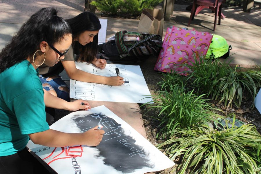 Sacramento State students Monica Linhthasack (closest) and Vanessa Trejo creating posters on Thursday March 29 in preparation for the event Linhthasack organized that will take place on April 3. Linhthasacks goal is demanding justice for Stephon Clark.