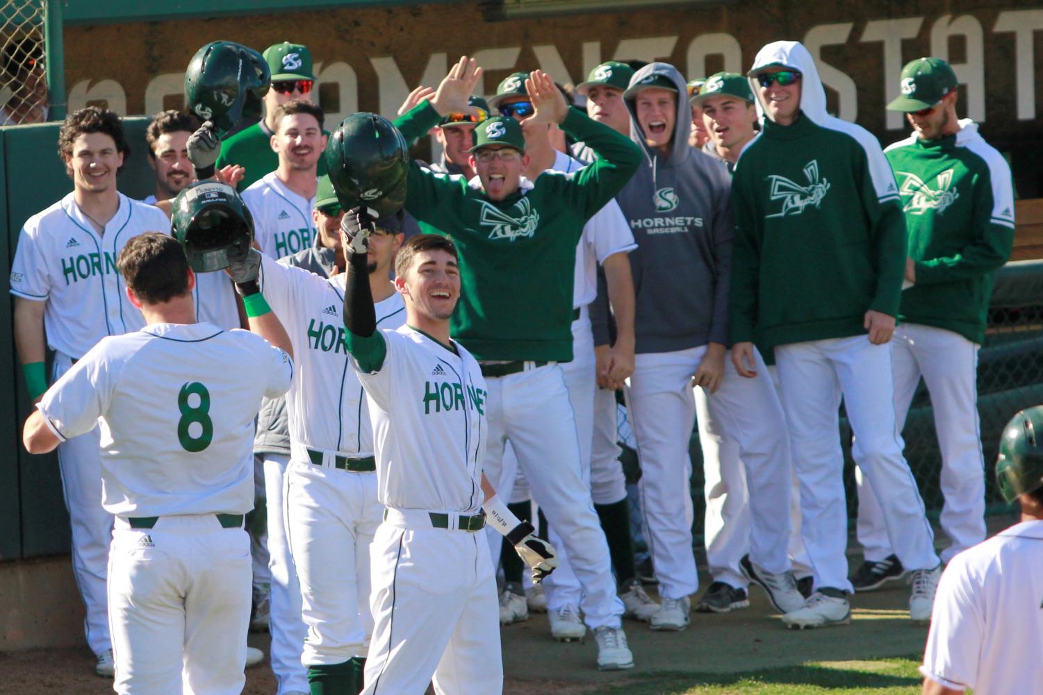 Sacramento State freshman infielder Steven Moretto, far left, celebrates with his teammates following his first home run of his career against the University of Washington at John Smith Field on Sunday, Feb. 18, 2018. The Hornets defeated the Huskies 6-0.