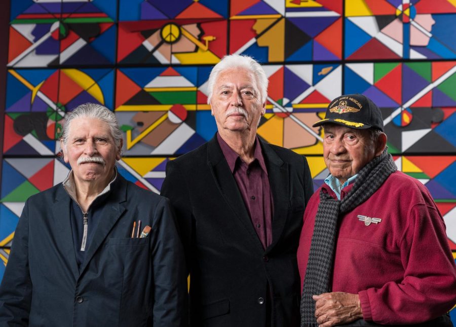 RCAF members Juanishi Orosco, left, Stan Padilla, and Esteban Villa pose in front of the lower panel of their mural.