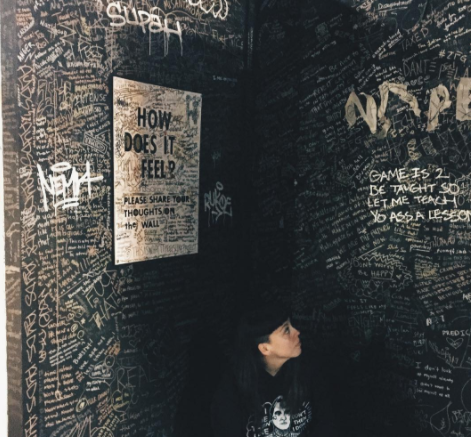 Artist and Sacramento State alumna Terra Lopez sits in front of the feedback wall at her interactive exhibit, “This is What it Feels Like.” The installation is coming to the University Library breezeway Monday, April 23 and Tuesday, April 24.