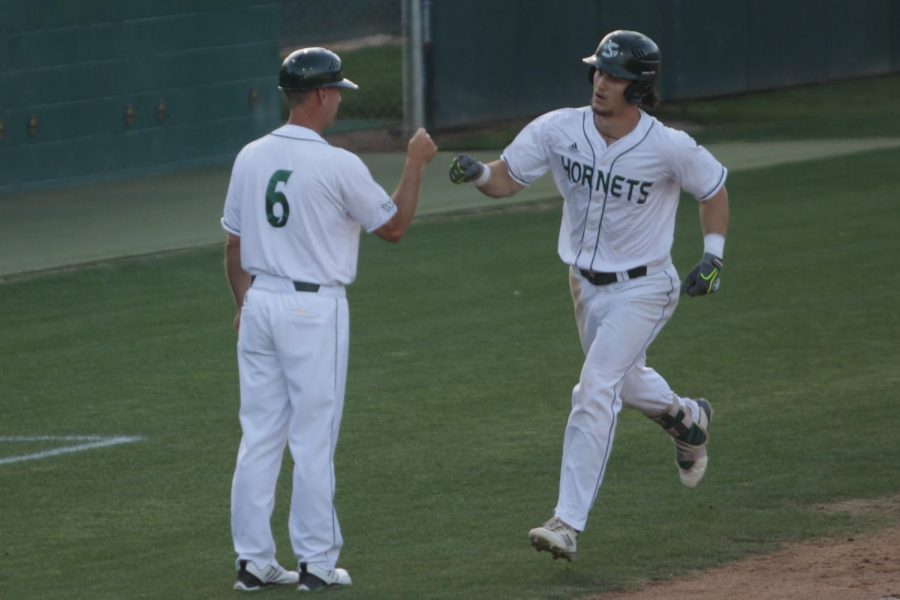 Sacramento State junior outfielder James Outman, right, celebrates with Sac State coach Reggie Christiansen, left, after Outman hit a home run against Seattle University on Saturday, May 5, 2018 at John Smith Field. Outman was selected by the Los Angeles Dodgers in the seventh round of the 2018 MLB Draft
