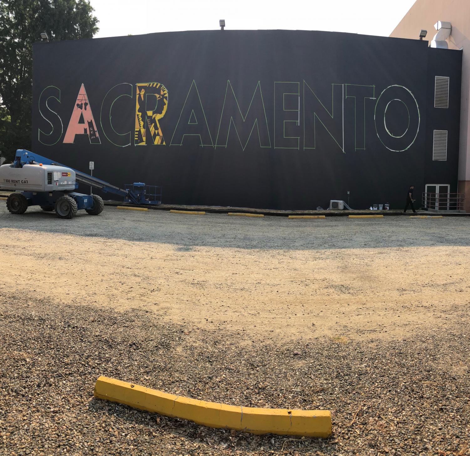 Raphael Delgado and nine other artists are completing this 'SACRAMENTO' mural on the side of Shasta Hall as part of the Wide Open Walls art festival that is being held from Aug. 9-19.
