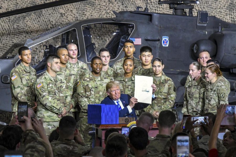 Trump signs the John S. McCain Defense Authorization Act  in Fort Drum, New York.