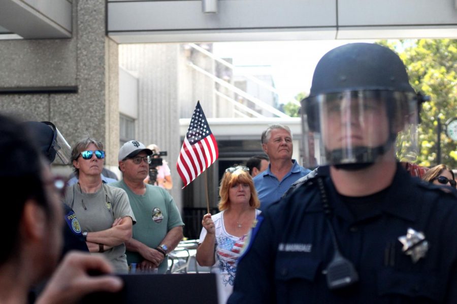 A counter-protester holds an American flag at the Black Lives Matter Protest Tuesday Sept. 18 in downtown Sacramento. Two groups of protesters clashed outside of a statewide law enforcement expo.