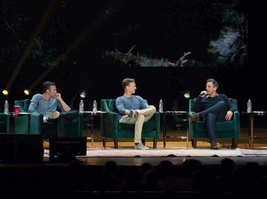 From left to right, Jon Favreau, Tommy Vietor and guest Seth Meyers at a live taping of Pod Save America at Radio City Music Hall in New York City.