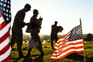 Team Hill Airmen carry flag bundles during a flag-placing detail at the Utah Veterans Memorial Park.