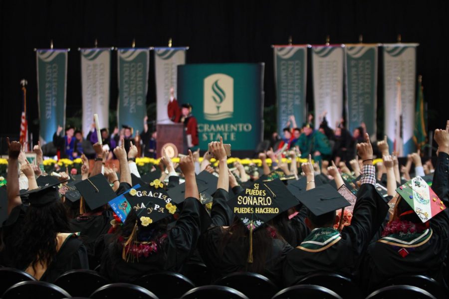 Students attending the Spring 2018 commencement ceremony held at Golden 1 Center join Sacramento State President Robert Nelsen in a ‘Stingers up’ salute after his address on May 18, 2018.  Nelsen announced an on-campus, drive-through commencement for the 2020 and 2021 graduating classes Monday in a SacSend email.