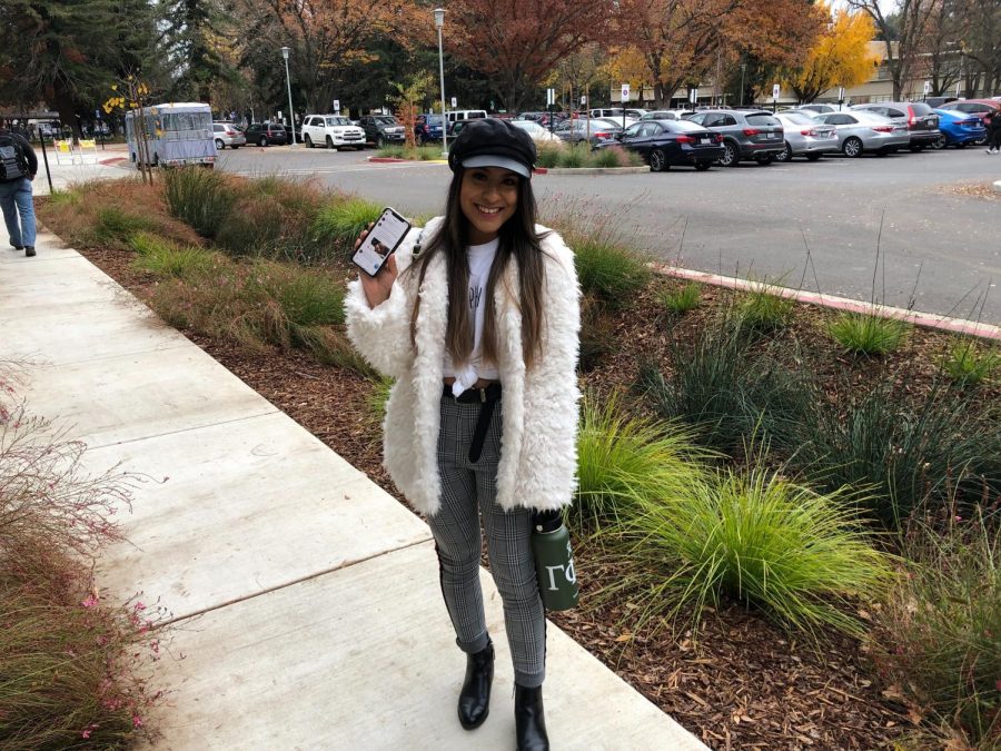 Sac State student and communications sciences and disorders major, Alejandra Machuca scrolls through Twitter on her way to the parking garage. 