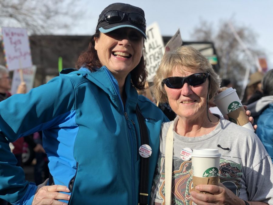 Scarlet Boggs and Kathrine Pinch walk in the women's march Saturday morning. Both women are professors in the Sac State RPTA department.