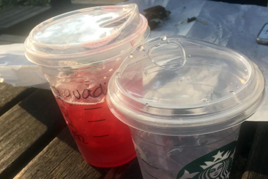 A pair of Starbucks cups with Nitro lids on a table outside the Riverfront Courtyard. The sippy cup style of lid is being used to replace straws on most Starbucks cold beverages below Trenta size.