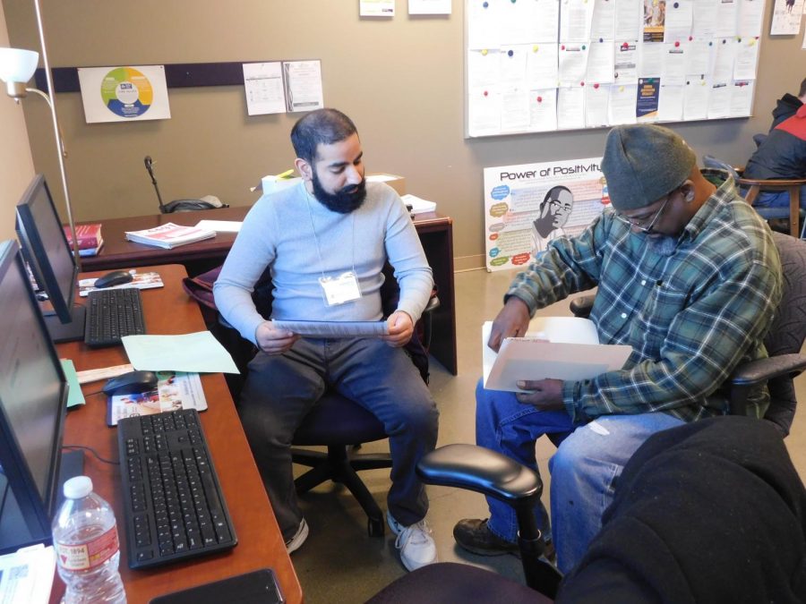 Sac State student volunteer Karandeep Gill assists an attendee with preparing his tax documents. The assistance was part of the free tax preparation event. 