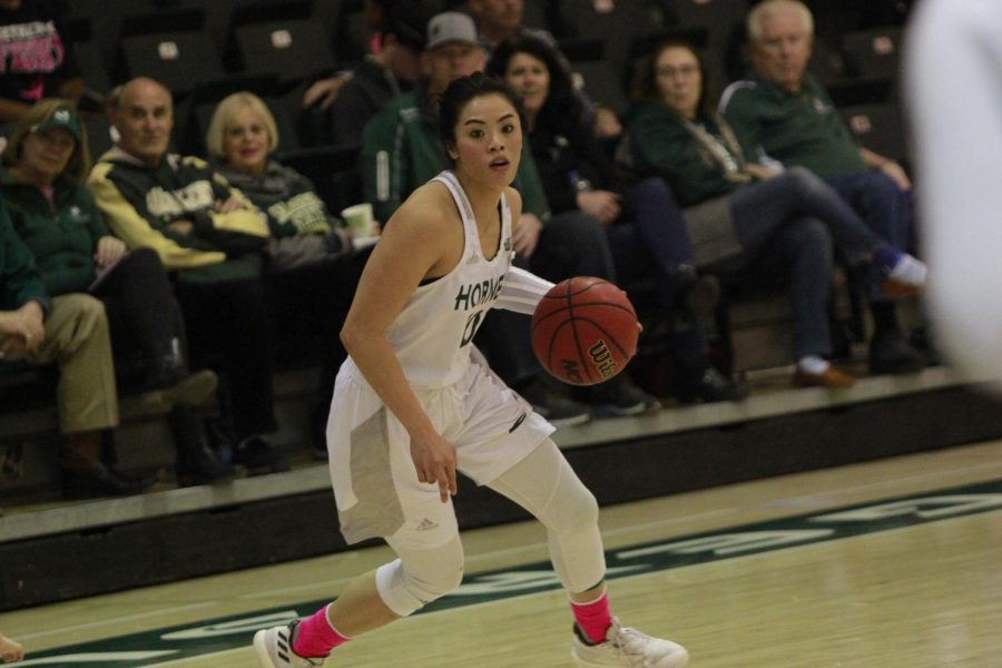 Sac State junior guard Gabi Bade crosses over in a 75-57 loss against Portland State Feb. 23 at the Nest. Bade finished with 20 points on five of 10 from three.