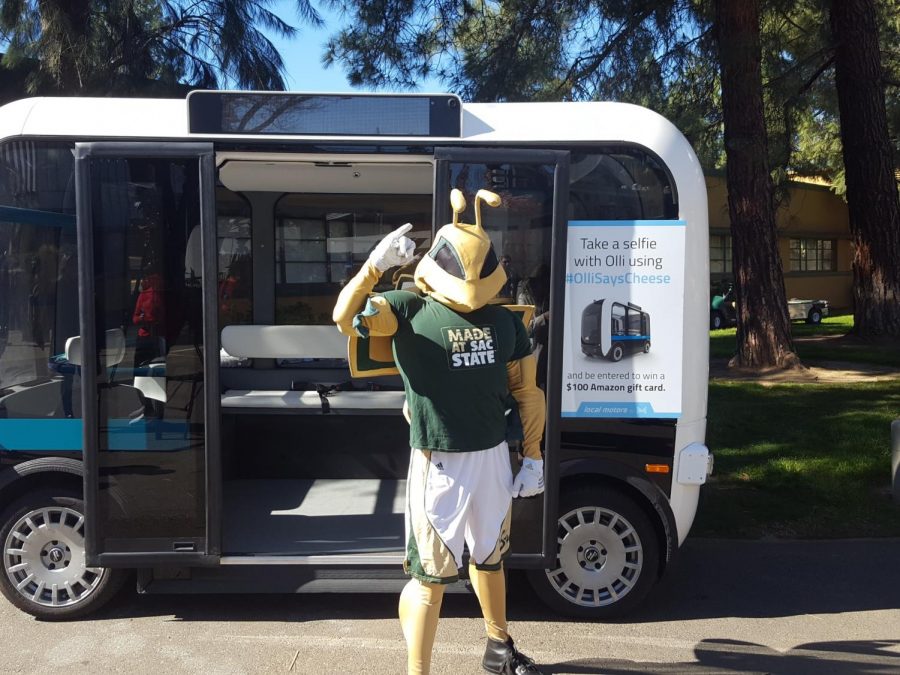 Sac+States+mascot+Herky+poses+with+a+driverless+vehicle+named+Olli+at+a+press+conference+at+the+Nest+Thursday.+Two+Olli+vehicles+will+start+giving+students+rides+around+campus+Friday.+