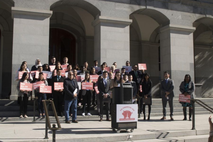 Mia Kagianas, president of the Cal State Student Association and former Sac State student stands at the podium to introduce Assemblymember Jose Medina at the financial aid reform rally Wednesday. Kagianas is an advocate for financial aid and student welfare.