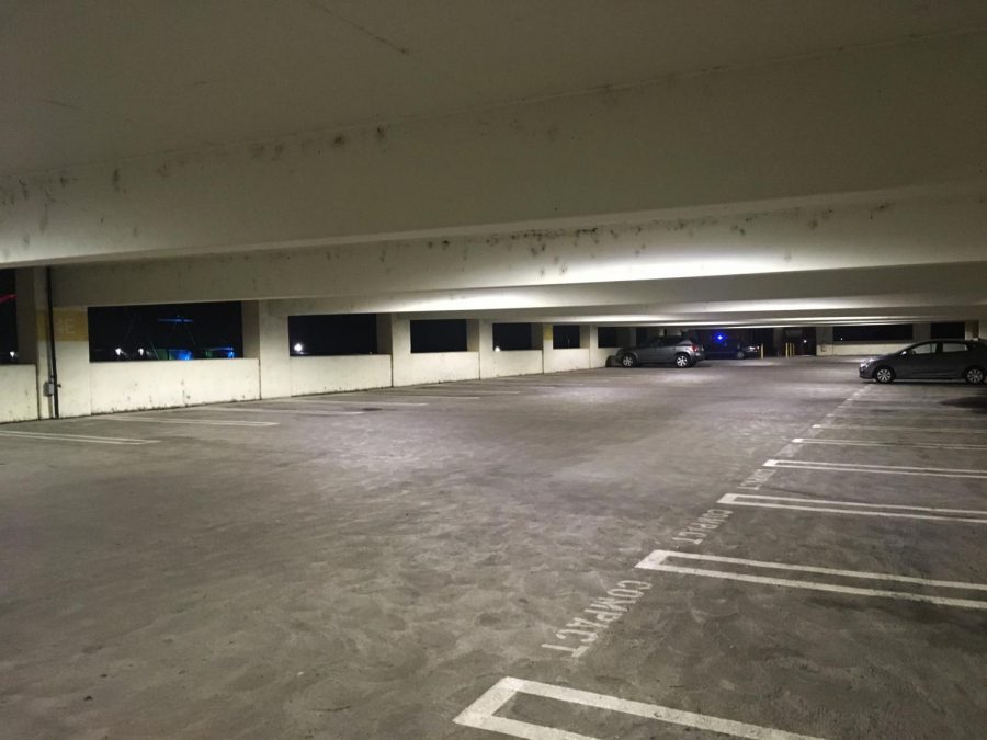 A few cars sit in a parking lot at Sacramento City College during the night. A new bill would allow homeless students at California Community Colleges to park their cars in campus parking lots overnight.