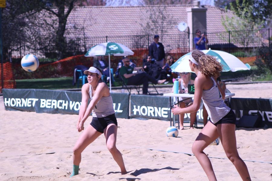 Sac State junior Paige Swinney gets in position to bump set the ball as sophomore Macey Hayden looks on in anticipation to make a play off the set. Sac State women’s beach volleyball went 1-3 in its first two-day tournament this season at Livermore Park in Folsom on Saturday, moving their record to 1-6 overall. 