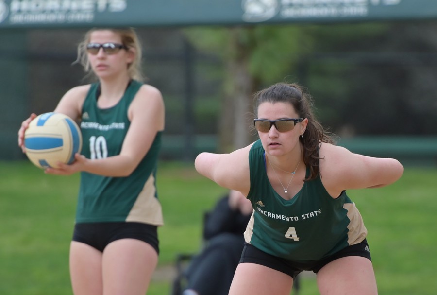 Ashtin Olin, sophomore prepares to serve as Mikaela Nocetti, senior, looks on in anticipation for the next play.
