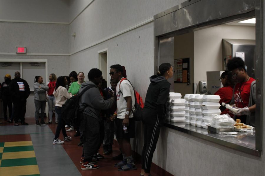 Attendees for the summit stand in line for a free meal courtesy of The Rose Family Creative Empowerment Center during the Stephon Clark Legacy Weekend in Meadowview Friday. They work to aid vulnerable youth throughout the Sacramento area and worked with the Clark family to organize the summit.