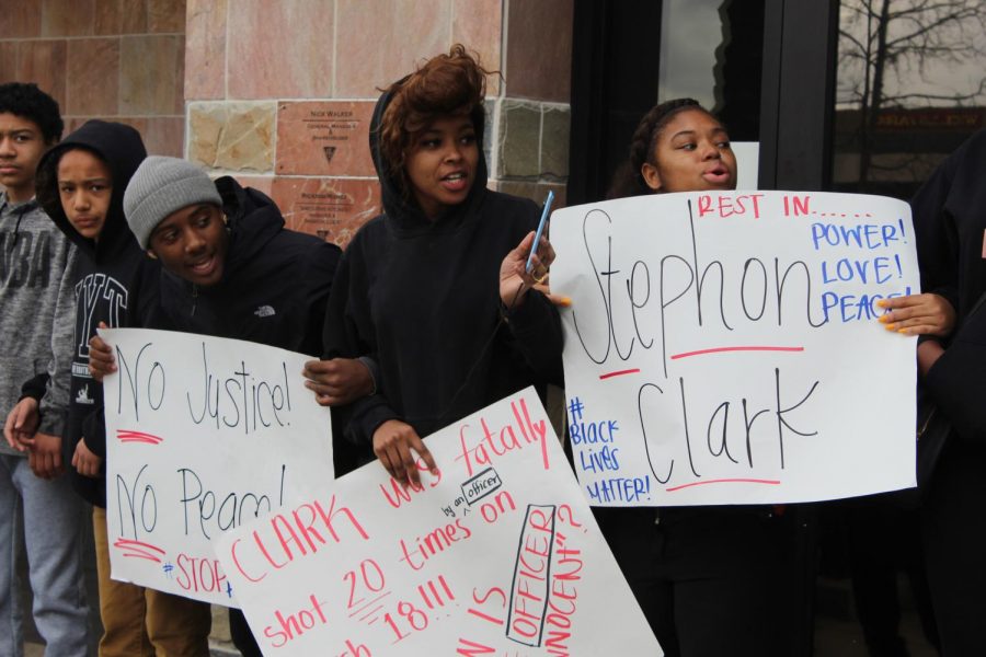 From right, Starr Leverette-James, a 19-year-old Sac State Spanish major, holds a sign with two other protesters outside of BJs Restaurant and Brewhouse at the Arden Fair Mall in Sacramento. The shopping center was closed Sunday due to high potential for unsafe numbers to gather (Sunday), mall officials said.