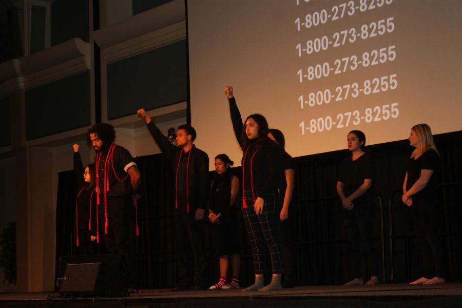 Members+of+A+Memory%2C+A+Monologue%2C+A+Rant%2C+and+A+Prayer%2C+perform+at+the+University+Union+Ballroom+Monday.+The+phone+number+in+the+background+connects+to+the+National+Suicide+Prevention+Lifeline.