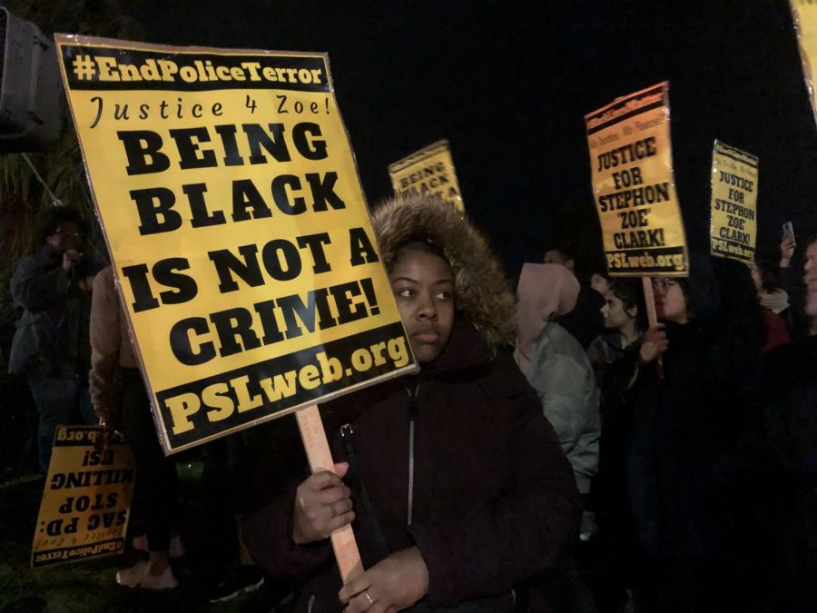 TKeyah+Robinson+holds+a+sign+at+a+vigil+for+Stephon+Clark+in+Meadowview+on+Friday.+The+vigil+was+held+to+honor++Clark+and+demand+for+the+imprisonment+of+the+officers+who+shot+him.%0A