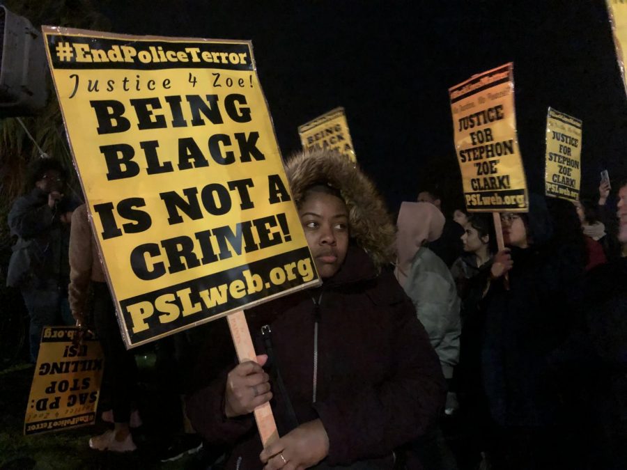 T'Keyah Robinson holds a sign at a vigil for Stephon Clark in Meadowview on Friday. The vigil was held to honor  Clark and demand for the imprisonment of the officers who shot him.
