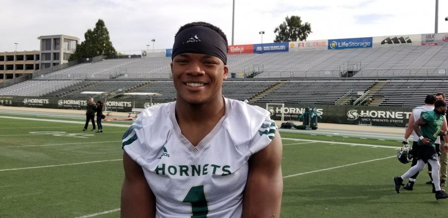 Junior running back Elijah Dotson smiles as spring football practices begins around him. As a sophomore in 2018, he led the team in rushing with over 1,000 yards. 