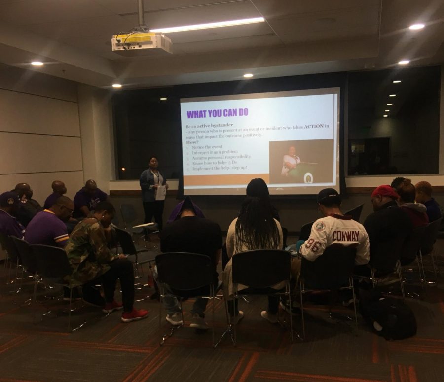 Students and members of Sac States Omega Psi Phi chapter listen to Health and Relationship Student Manager Bajha Jordan speak on the meaning and importance of consent. The slide presented details regarding  what bystanders can do to stop a possible assault before it happens. 